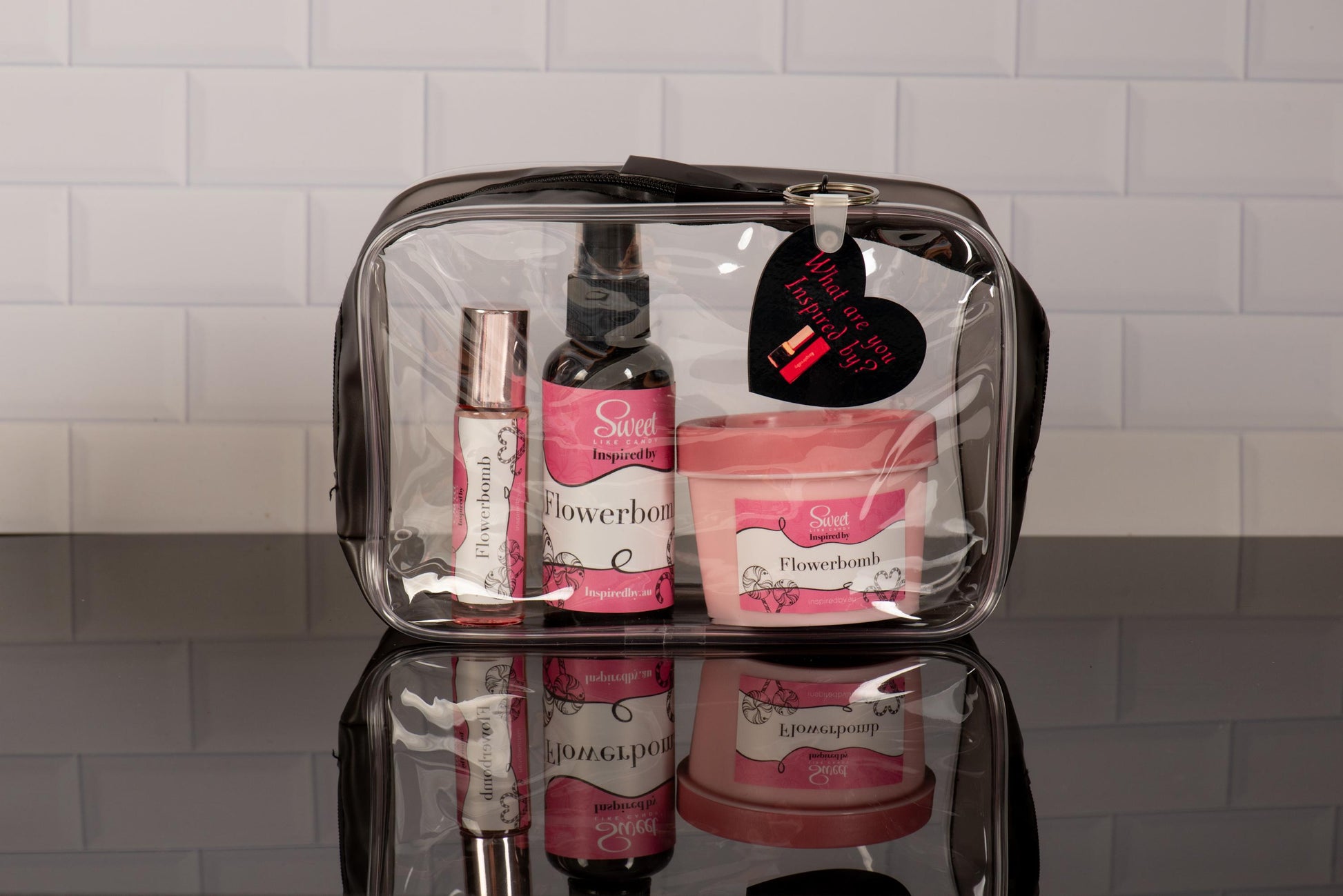 InspiredBy clear travel cosmetic bag with designer-inspired perfume oils and beauty products - perfect for organizing your favorite fragrances on-the-go