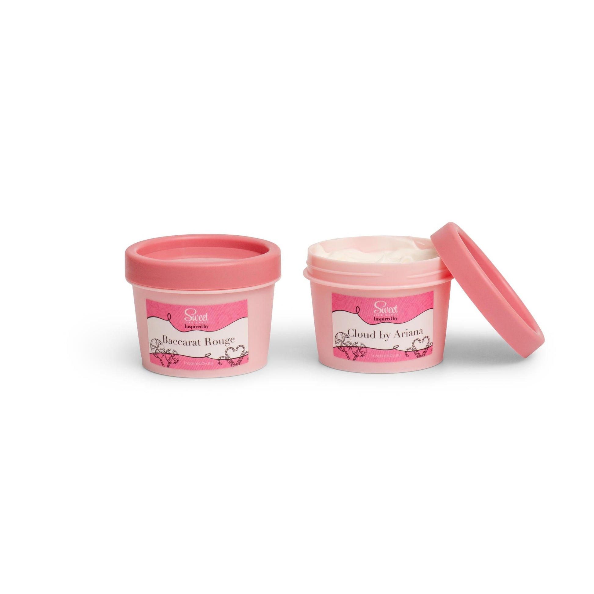 Two open containers of body moisturizer with pink lids, one labeled for men and the other for women.
